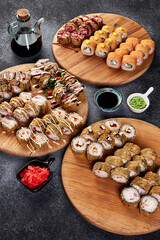 set of hot rolls on a wooden plate on a gray background