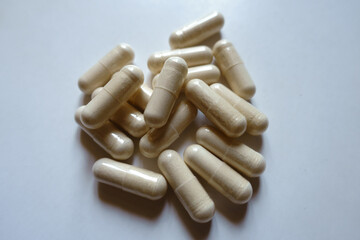Closeup of heap of light beige capsules of Saccharomyces boulardii probiotic