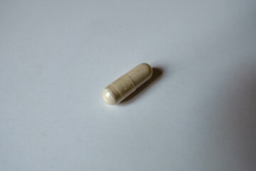 Close view of one light beige capsule of Saccharomyces boulardii probiotic