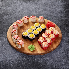 set of rolls on a round wooden board on a gray background