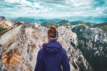 Young woman enjoys beautiful view from Seekofel on the Dolomite mountains at noon.Seekofel,...