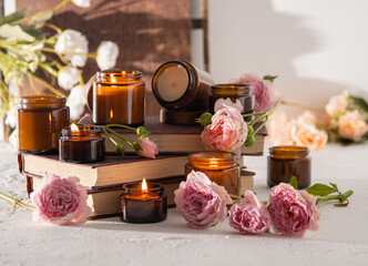 A set of different aroma candles in brown glass jars. Scented handmade candle. Soy candles are burning in a jar. Aromatherapy and relax in spa and home. Fire in brown jar.