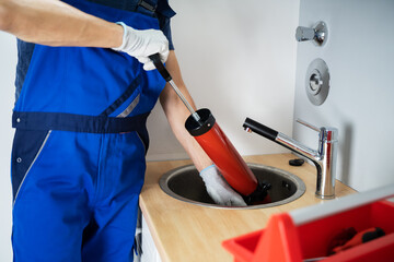 Plumber Cleaning Drain And Sink