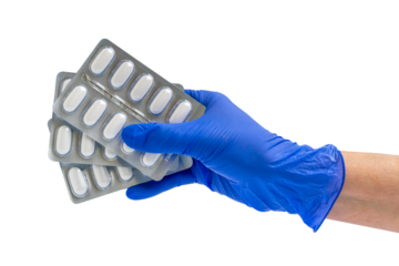 Doctor or scientist hand in blue nitrile glove holds capsule packs