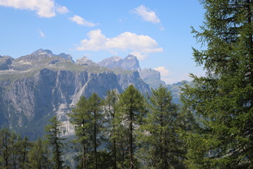 Val Badia, Italy-July 17, 2022: The italian Dolomites behind the small village of Corvara in summer days with beaitiful blue sky in the background. Green nature in the middle of the rocks.