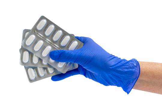 Doctor or scientist hand in blue nitrile glove holds capsule packs