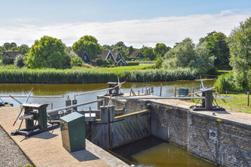 Fototapeta na wymiar Oudesluis, Netherlands. August 2022. A small manually operated lock in the polder of North Holland.