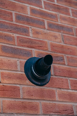 Central heating boiler flue on the exterior of a brick house in United Kingdom