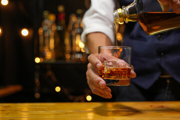 Bartender pouring Whiskey, on  bar,