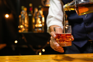 Bartender pouring Whiskey, on  bar,