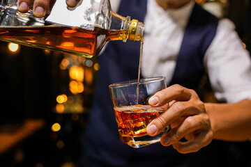 Bartender pouring Whiskey, on  bar,