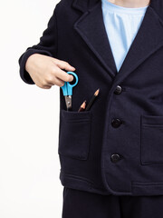 School suit for boy on white background. Dark blue jacket and trousers. Comfortable pocket. First grader