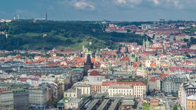 Panoramic view of Prague with railway station timelapse from the top of the Vitkov Memorial, Czech Republic. Old Town with red roofs. Cloudy sky at summer day