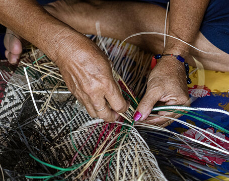 Central Kalamantan, Indonesia; May 20, 2022 - Woman makes baskets by hand.
