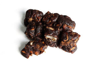 Tamarind isolated on a white background, wet tamarind is a popular condiment used to boil, curry or make dipping sauces. Tamarind is used as a substitute for the mellow sour taste.