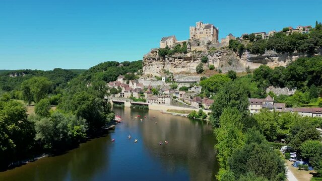 Aerial view Beynac castle and canoes on the river dordogne perigord France, High quality video