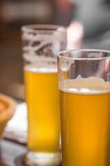 Two glasses of light beer with foam on table at a craft czech brewery. Weekend meeting with friends. Oktoberfest concept
