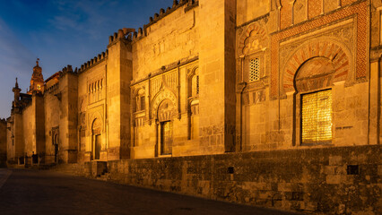 Street view of the Mosque–Cathedral of Córdoba also known as Mezquita at dusk. Beautiful Moorish architecture in Andalusia region, Spain.
