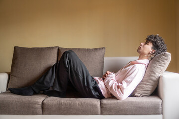 man lying on sofa relaxing