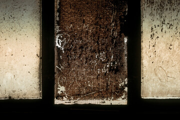 Background heavy industry abstract very dirty window in a factory in transmitted light with doodles