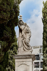 Resigned and grieving statue on the grave of a dead person as a sign of remembrance and respect for the deceased in the cemetery of Sitges Concept of the Day of the Dead, All Saints Day and Halloween