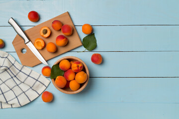 Naklejka na ściany i meble Composition with ripe apricots on wooden background, top view