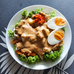 Gado gado or mixed vegetables with peanut sauce is a traditional salad from Indonesia that influenced by Portuguese. 