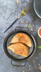 Karipap pusing or curry puff is one of Malaysian food which is made of several layers of crunchy skin with curry spiced potato filling and beef or chicken.
