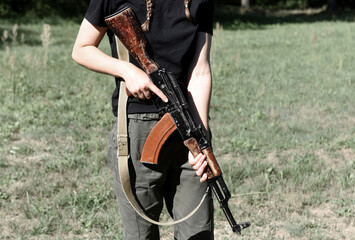 Fototapeta na wymiar Woman with AK assault rifle. Tactical exercises. War in Ukraine