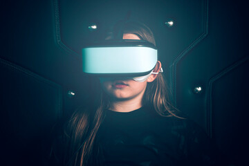 Cyberspace. Girl wearing virtual goggles, watching virtual reality vision, enjoying the fun cyber experience. . High quality photo