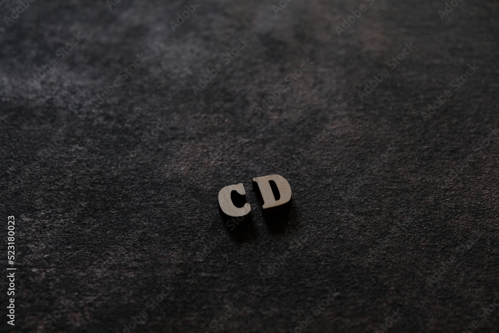 Fototapete the letters c and d above the dark field. initials cd