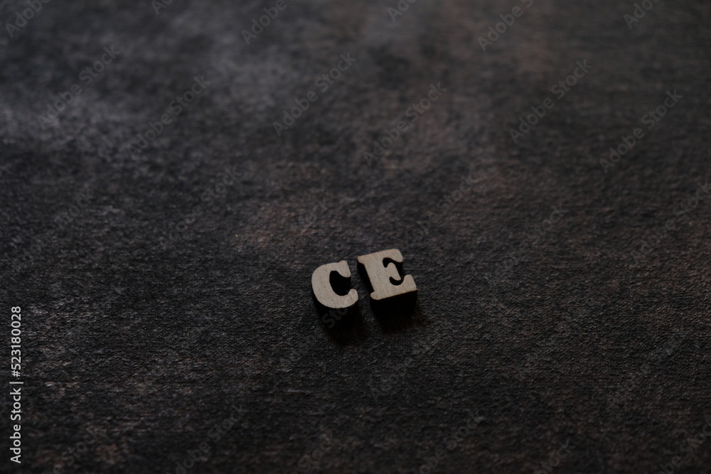 Poster the letters c and e above the dark field. initials ce