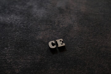 The letters C and E above the dark field. Initials CE