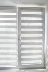 Window roller duo system day and night. Close up on roll curtains indoor.