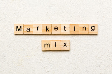 MARKETING MIX word written on wood block. MARKETING MIX text on cement table for your desing, concept