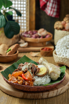 Nasi Gudeg. A signature rice dish from Jogjakarta. Jack fruit stew accompanied with spicy stew of cattle skin crackers and white chicken curry. In the background are the individual dish of gudeg meal.