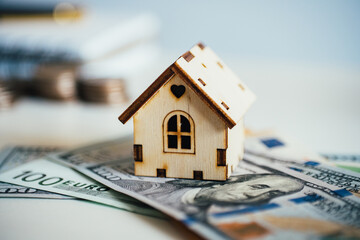 Mortgage concept. The house model is worth the money. Bank loan.