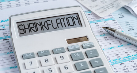 A calculator with the word Shrinkflation on the display