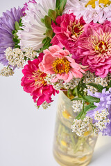 A bouquet of bright flowers on a light background.