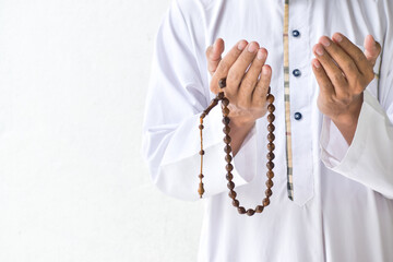 Religious muslim islam man in white session lift two hand for praying to Allah in mosque, isolated on white background.concept for islamic pray, Ramadan, Eid al Fitr, eid ad-ha, meditation