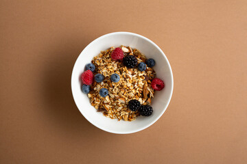 Top view of grains granola with fresh berries in bowl breakfast food concept blueberry on brown surface