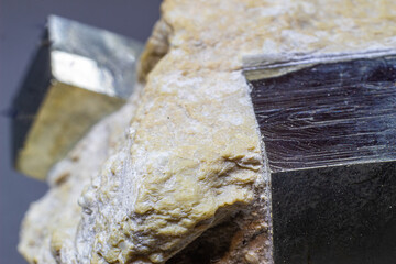 Macro cubical pyrite on white matrix isolated on gray background 