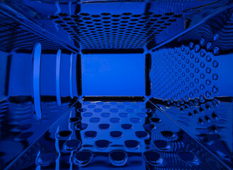An abstract inside view of a food grater reflecting blue.