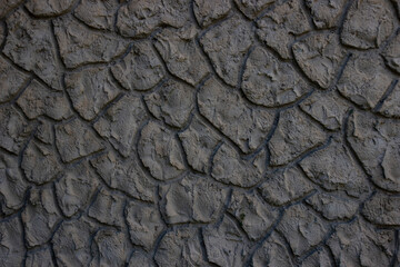 Imitation of the texture of a dark gray stone wall.