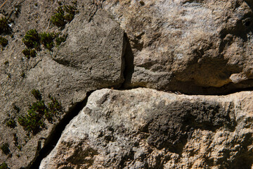 Fototapeta na wymiar Imitation of a gray-brown stone wall in close-up.