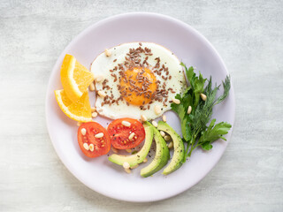 Fried egg with fresh vegetables on a plate