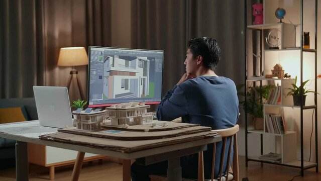 Asian Male Engineer Thinking While Designing House On A Desktop At Home. Cyber Games House Design And Decoration
