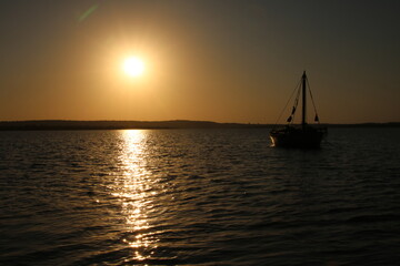 Fototapeta na wymiar Reflection of the Sunrise on the Water in the Bay of Maputo 