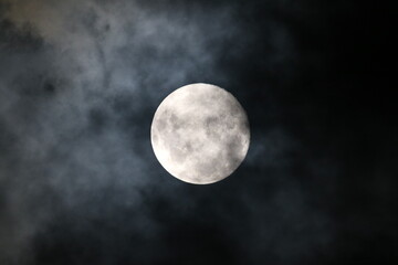 Fototapeta na wymiar A Cloudy Moon in a Dark Night 
