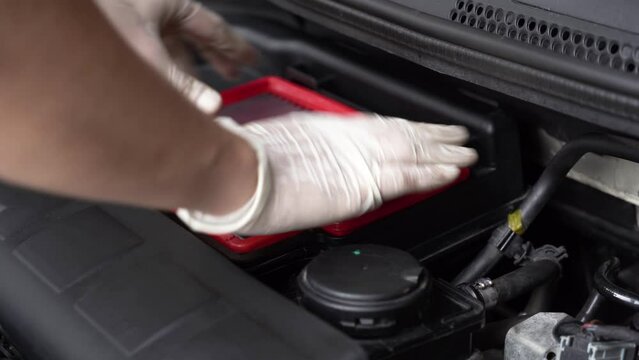 auto mechanic replaces parts. car service. close-up.